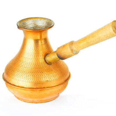 Vintage copper cezve close up isolated on white background.