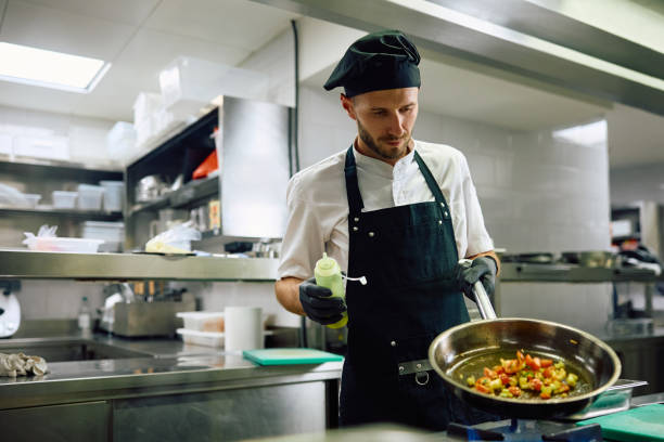 Professional chef working in the kitchen in a restaurant. copy space.